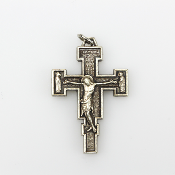 Extreme Humility Crucifix pendant. The backside has a pebbled texture and is marked "Italy" near the bottom.