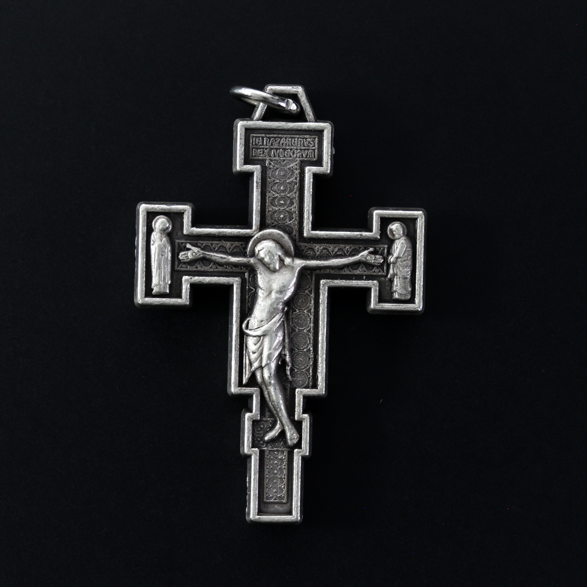 Extreme Humility Crucifix pendant. The backside has a pebbled texture and is marked "Italy" near the bottom.