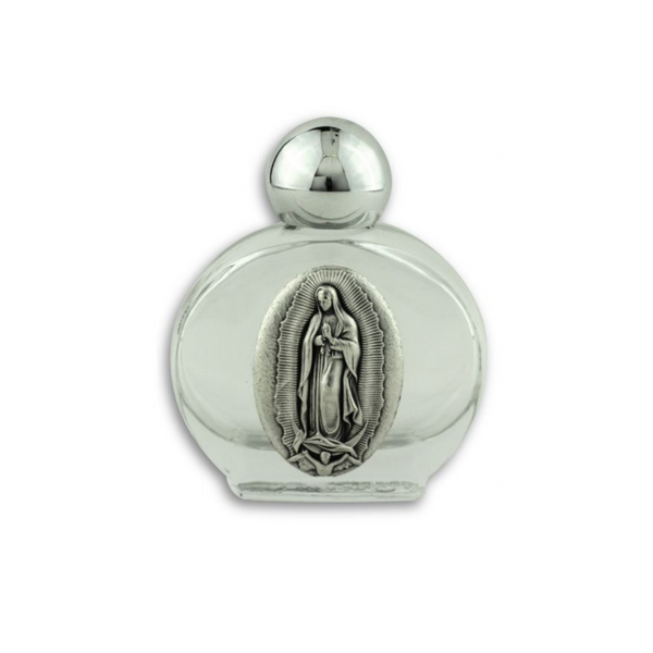 Glass holy water bottle with a metal embossed plaque of Our Lady of Guadalupe on the front. Plastic screw on cap that is a shiny silver tone color