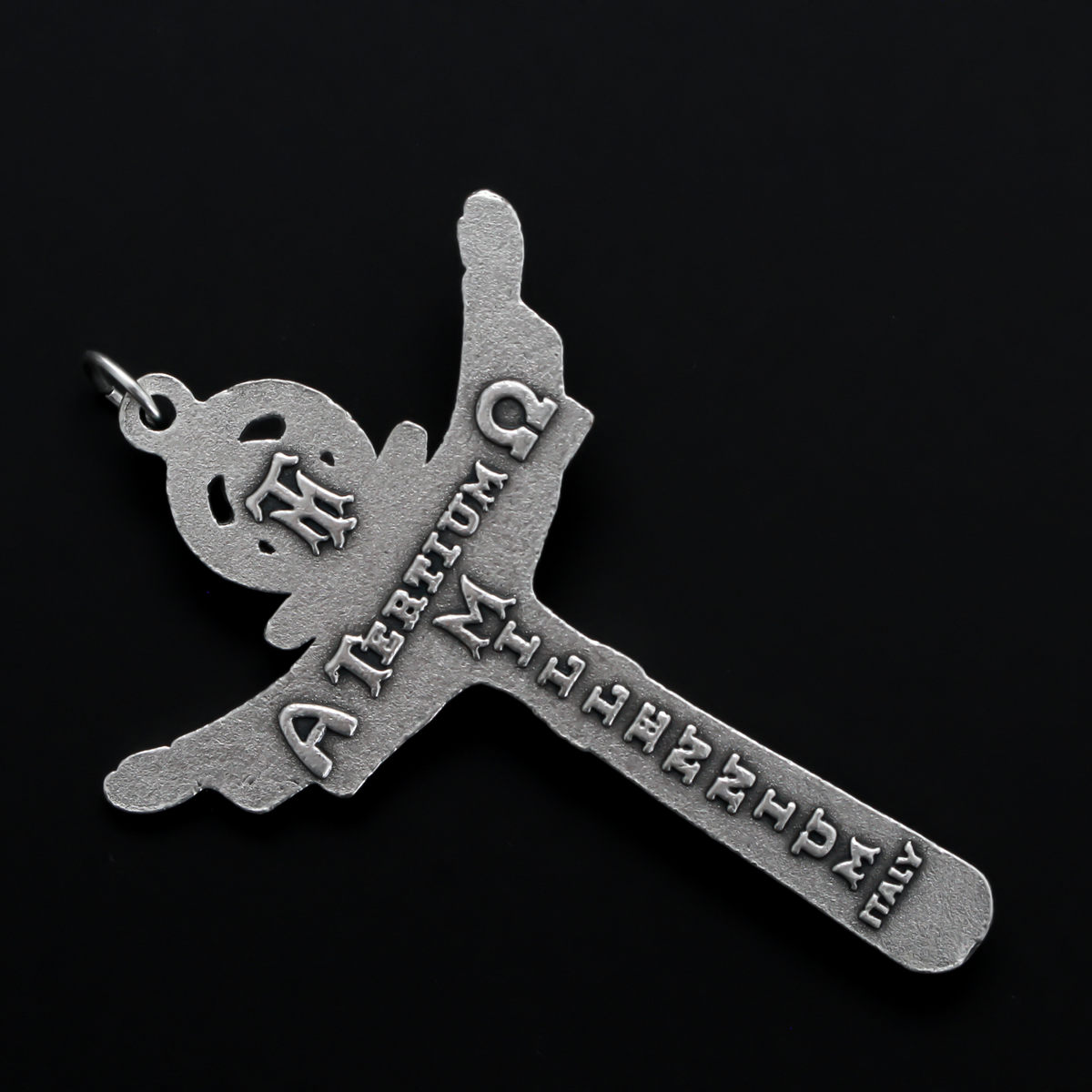 Holy trinity crucifix with the father, the son, and the holy ghost represented on the front of the crucifix. The backside of the cross is marked "Tertium Millennium" with the Greek letters Alpha and Omega