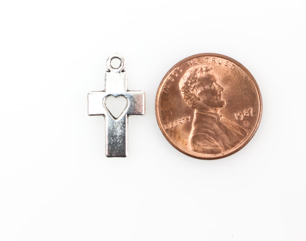 silver tone christian cross charm with cutout heart design