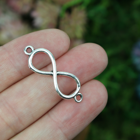 Silver-tone infinity symbol connector links with loops on the ends, 30mm long
