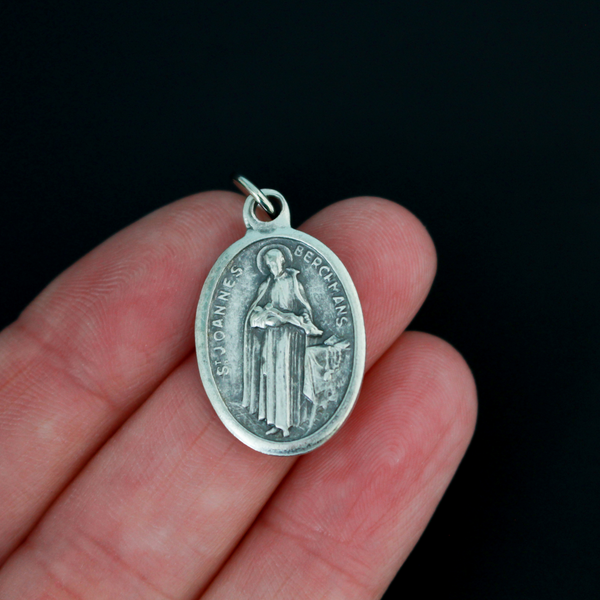 Saint John Berchmans medal. The front depicts the saint and the reverse is marked "Pray For Us".