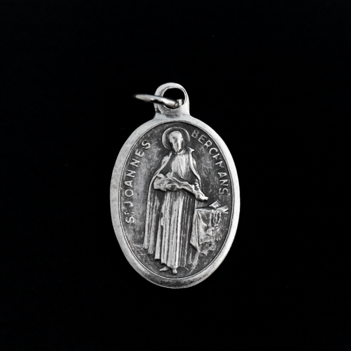 Saint John Berchmans medal. The front depicts the saint and the reverse is marked "Pray For Us".