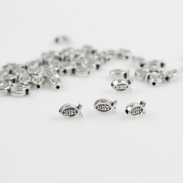Tiny silver fish shaped beads with Jesus written on both sides, 8mmx5mm