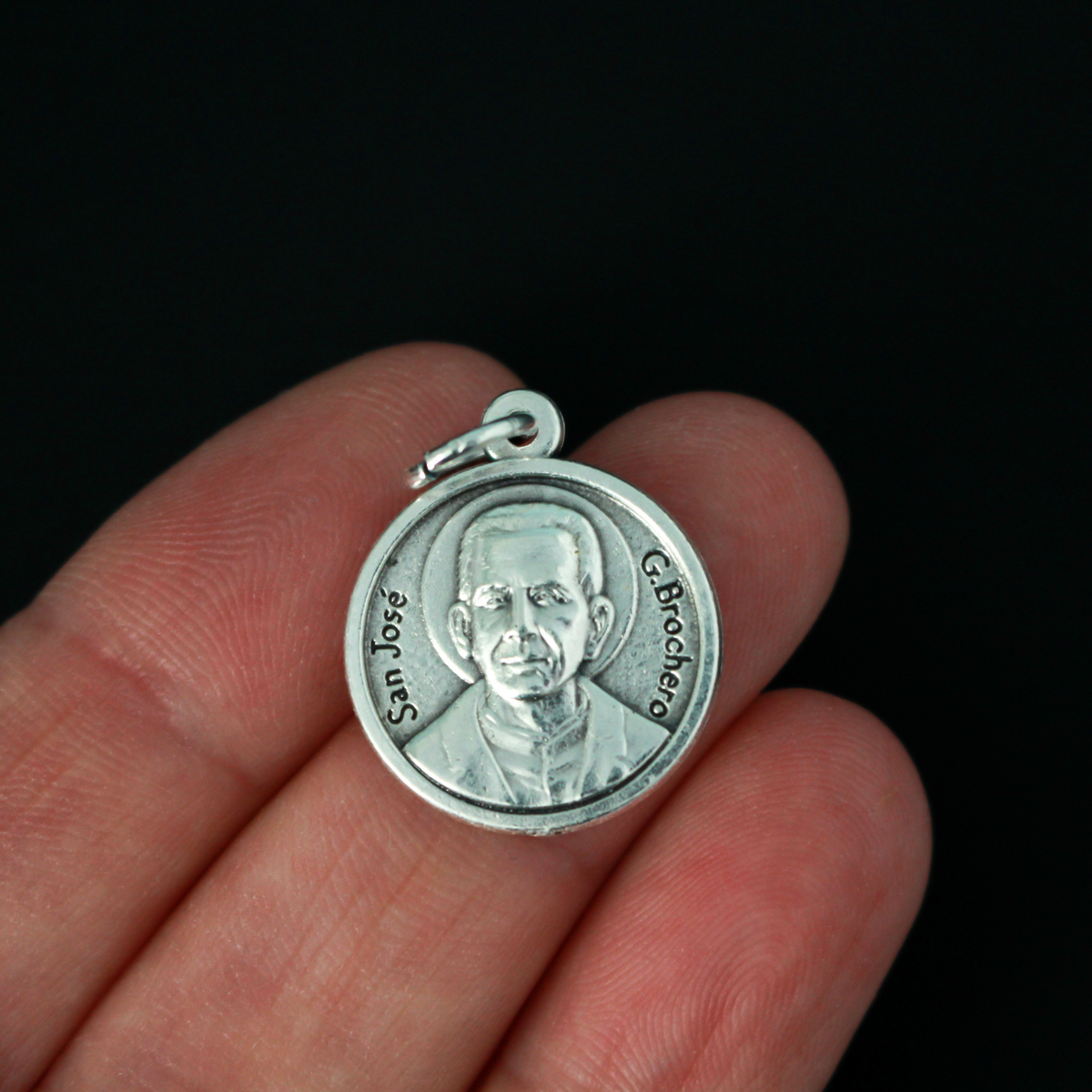 Saint José Gabriel del Rosario Brochero medal. The front depicts the saint and the reverse is marked "Pray For Us" in Spanish: Ruega Por Nosotros