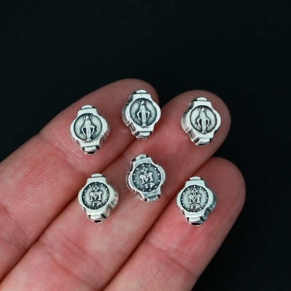 Miraculous Medal oval beads that are silver oxidized base metal made in Italy.