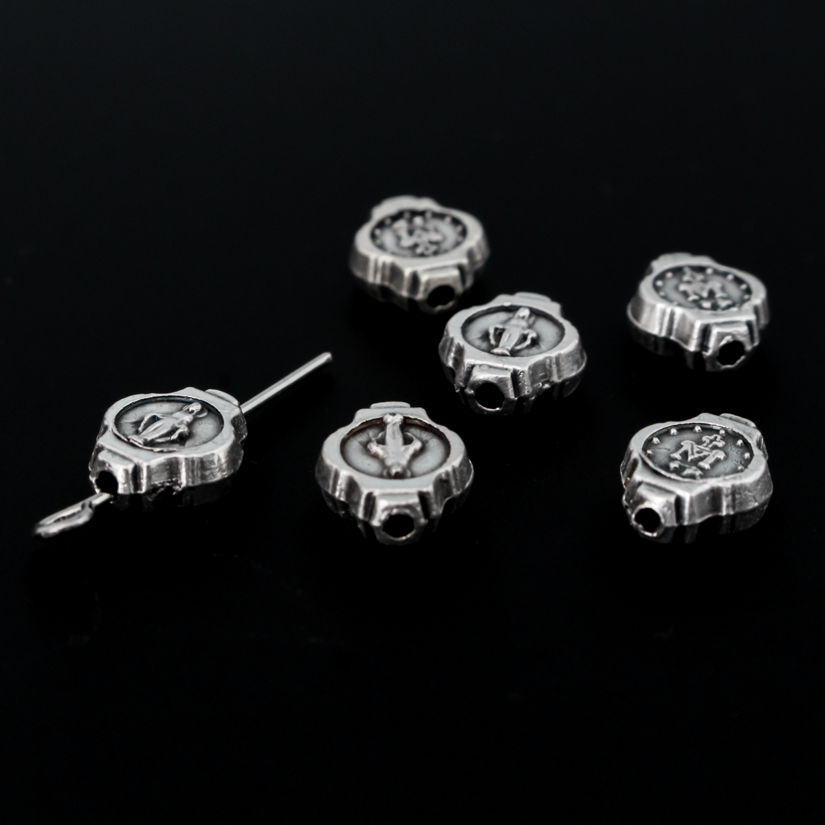 Miraculous Medal oval beads that are silver oxidized base metal made in Italy.