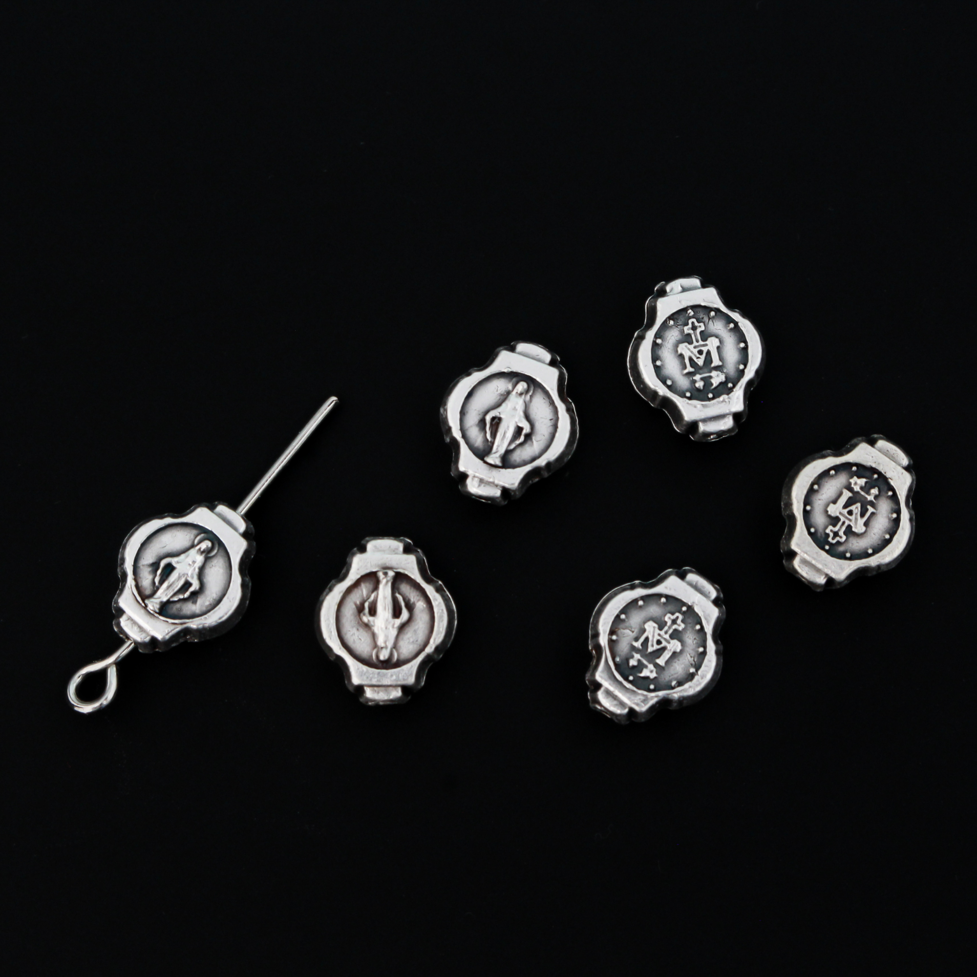 Miraculous Medal oval beads that are silver oxidized base metal made in Italy.