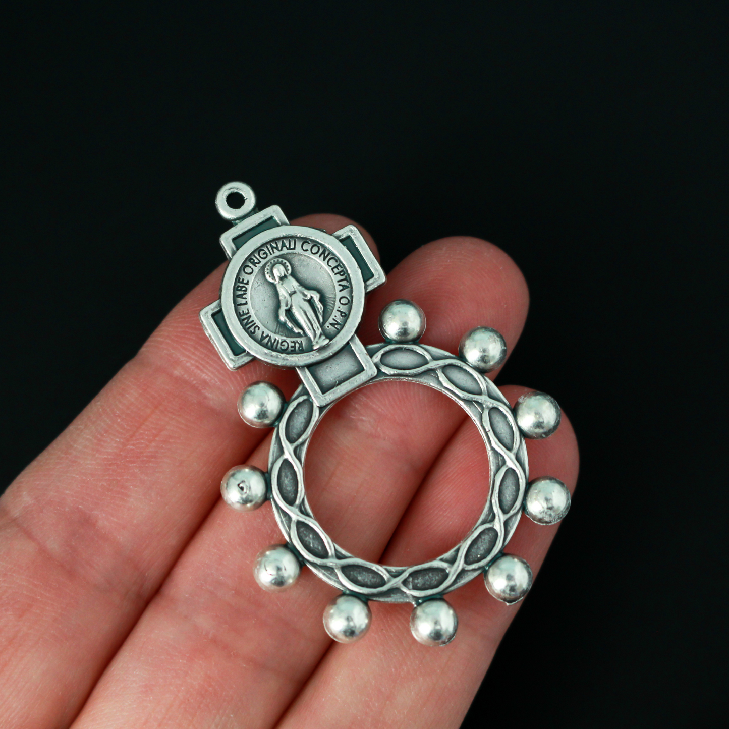 One decade rosary that features the Miraculous Medal in the cross