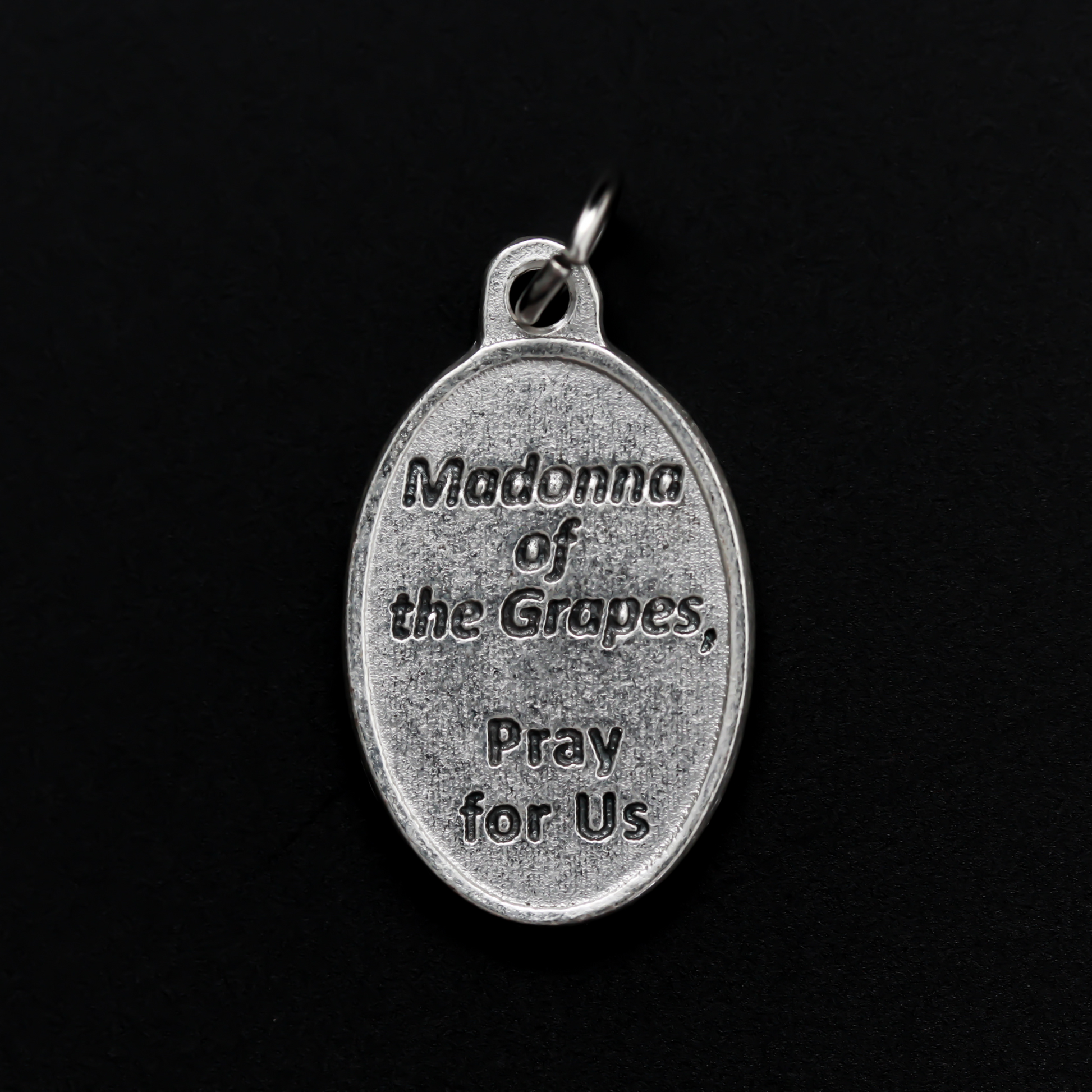 Our Lady of the Grapes medal that depicts Our Lady on the front and the words "Madonna of the Grapes Pray For Us" on the back.