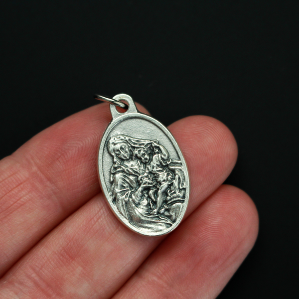 Our Lady of the Grapes medal that depicts Our Lady on the front and the words "Madonna of the Grapes Pray For Us" on the back.