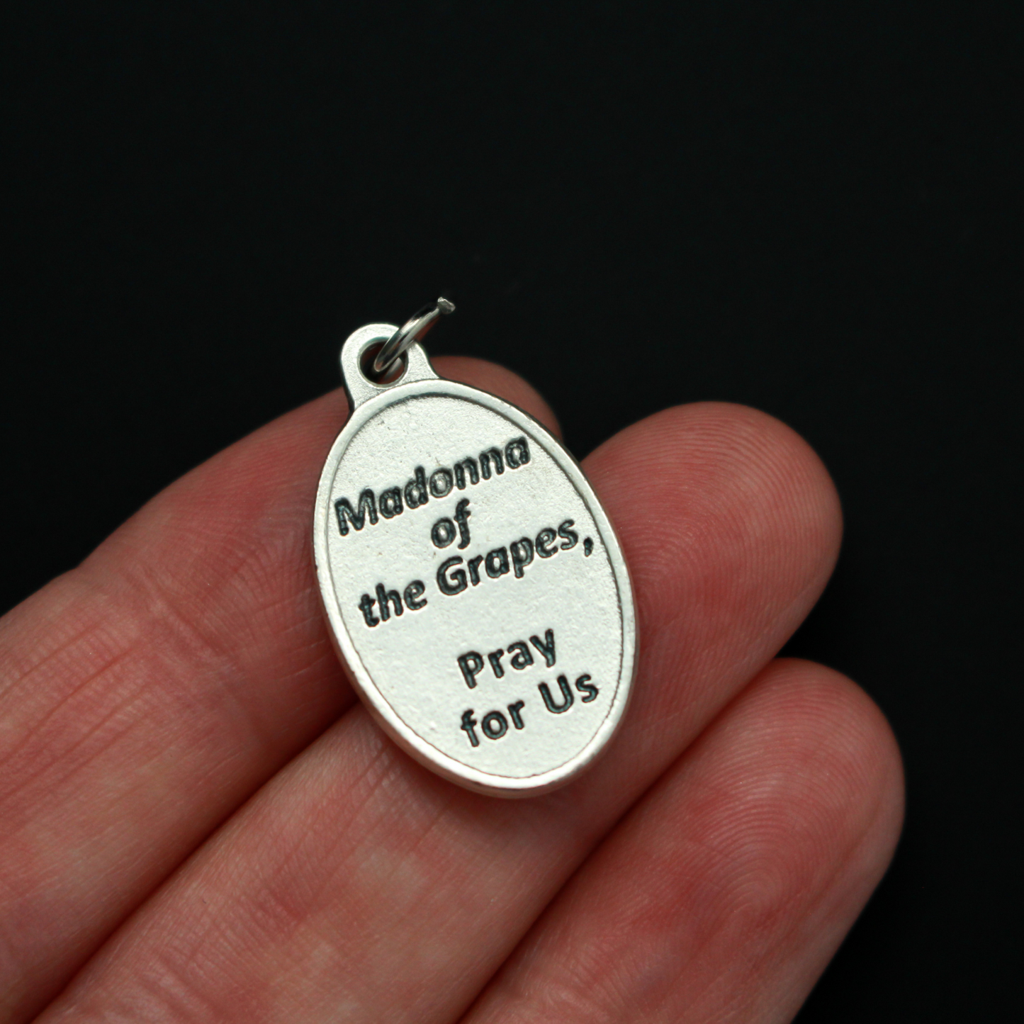 Our Lady of the Grapes medal that depicts Our Lady on the front and the words "Madonna of the Grapes Pray For Us" on the back.