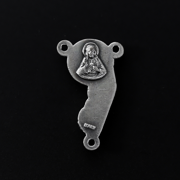 rosary centerpiece with an embossed image with a profile of our Mother Mary and the Child Jesus on the front, and an embossed image of the Sacred Heart of Jesus on the reverse