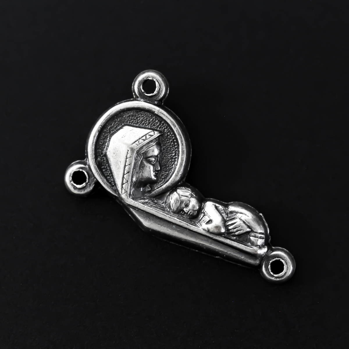 rosary centerpiece with an embossed image with a profile of our Mother Mary and the Child Jesus on the front, and an embossed image of the Sacred Heart of Jesus on the reverse
