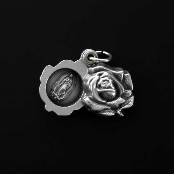 Our Lady of Guadalupe medal that is a rose locket that slides open to reveal the medal inside.