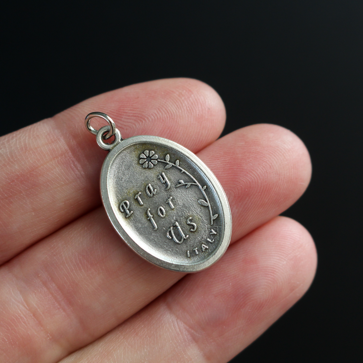 Our Lady of Perpetual Help medal. The reverse side of the medal is inscribed with "Pray For Us"