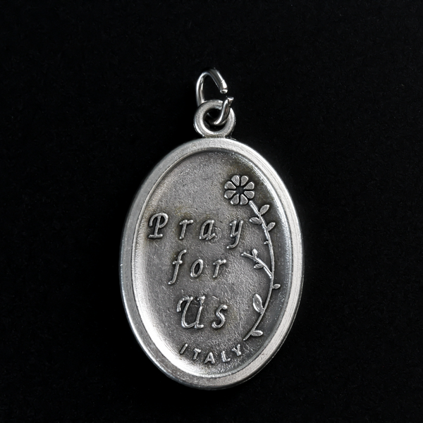 Our Lady of Perpetual Help medal. The reverse side of the medal is inscribed with "Pray For Us"