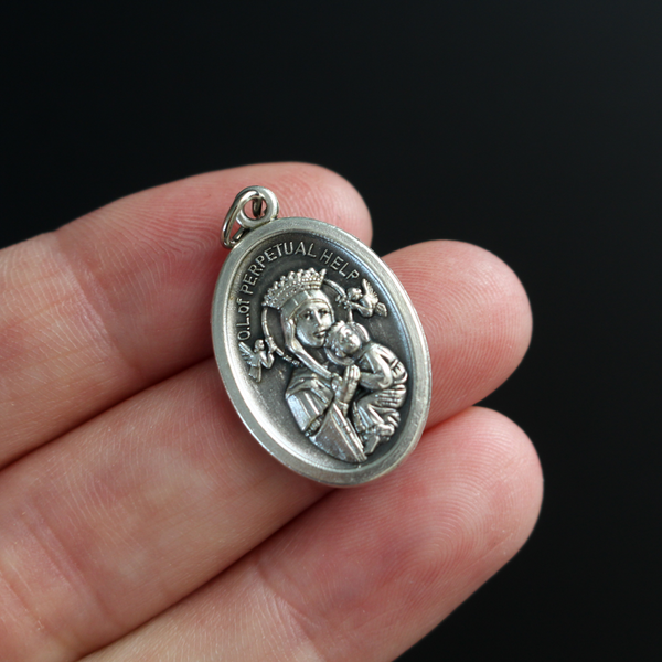 Our Lady of Perpetual Help medal. The reverse side of the medal is inscribed with "Pray For Us"
