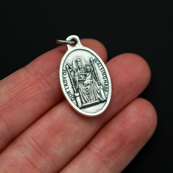 Our Lady of Walsingham medal that depicts Our Lady on the front and the words "Our Lady of Walsingham Pray For Us" on the back.