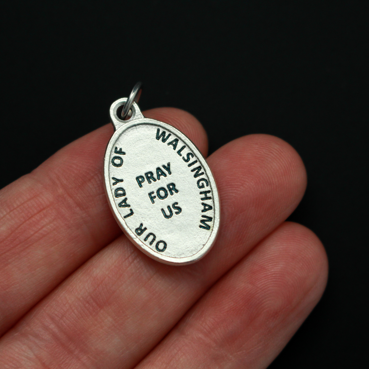 Our Lady of Walsingham medal that depicts Our Lady on the front and the words "Our Lady of Walsingham Pray For Us" on the back.