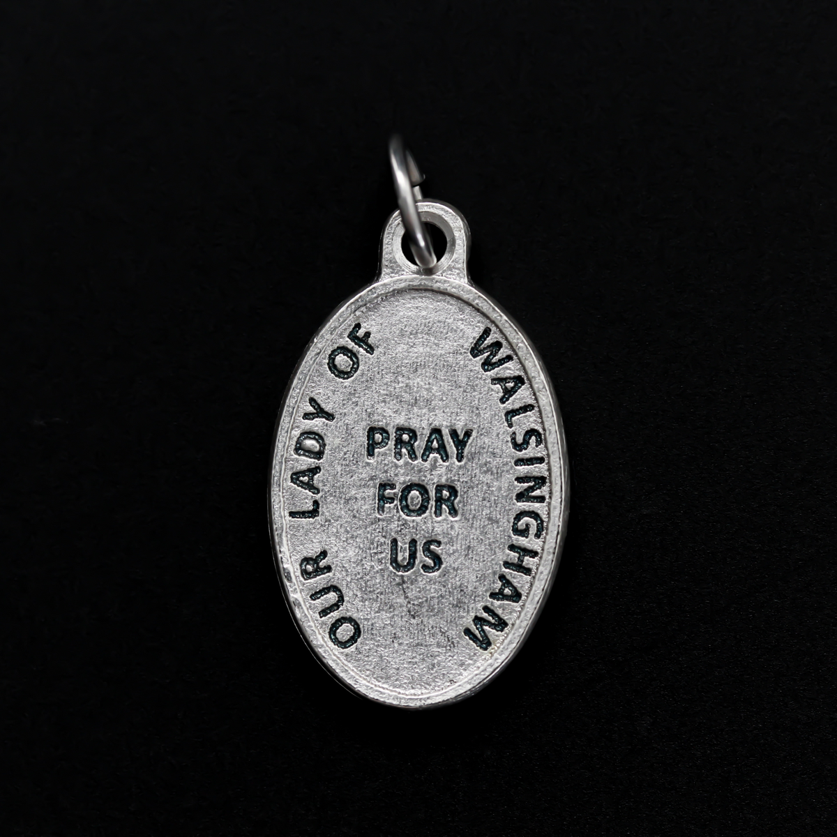Our Lady of Walsingham medal that depicts Our Lady on the front and the words "Our Lady of Walsingham Pray For Us" on the back.