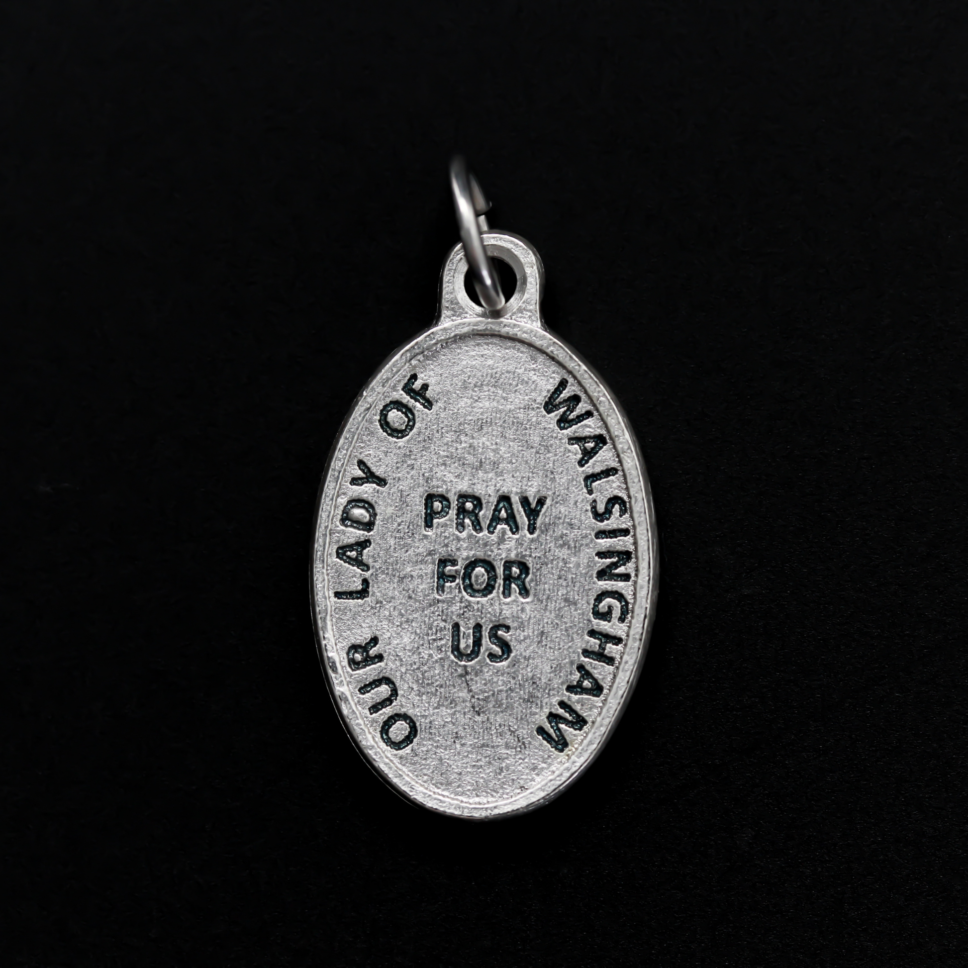 Our Lady of Walsingham medal that depicts Our Lady on the front and the words "Our Lady of Walsingham Pray For Us" on the back.