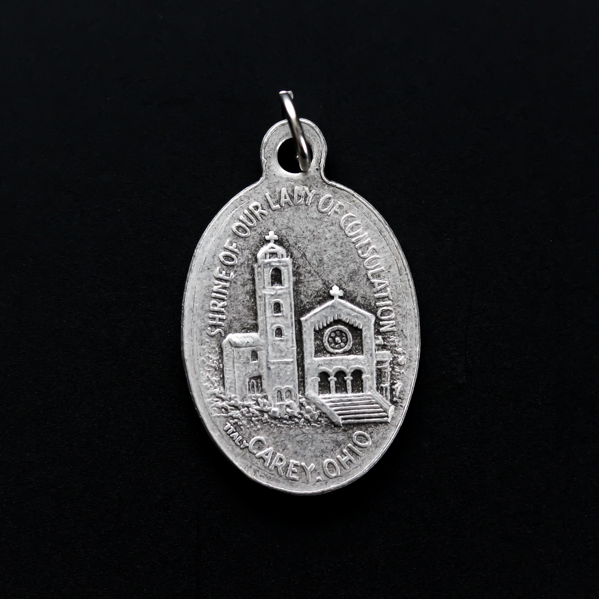 Our Lady of Consolation medal that depicts Our Lady on the front and the Shrine of Our Lady of Consolation in Carey, Ohio on the backside