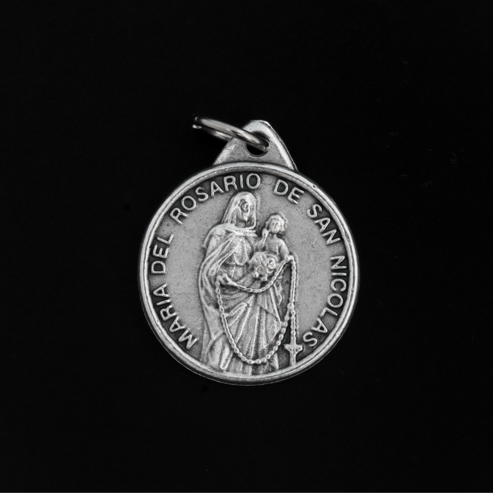 The front of the medal features an embossed image from the reported apparitions of Maria del Rosario de San Nicolas, Argentina.