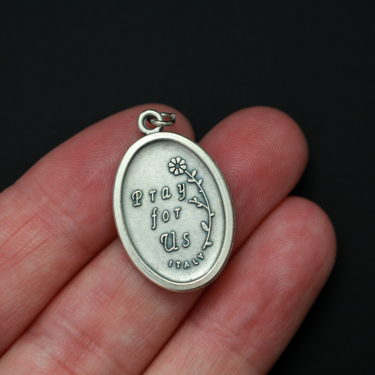Saint Lucy medal that depicts the saint on the front and "Pray For Us" on the back