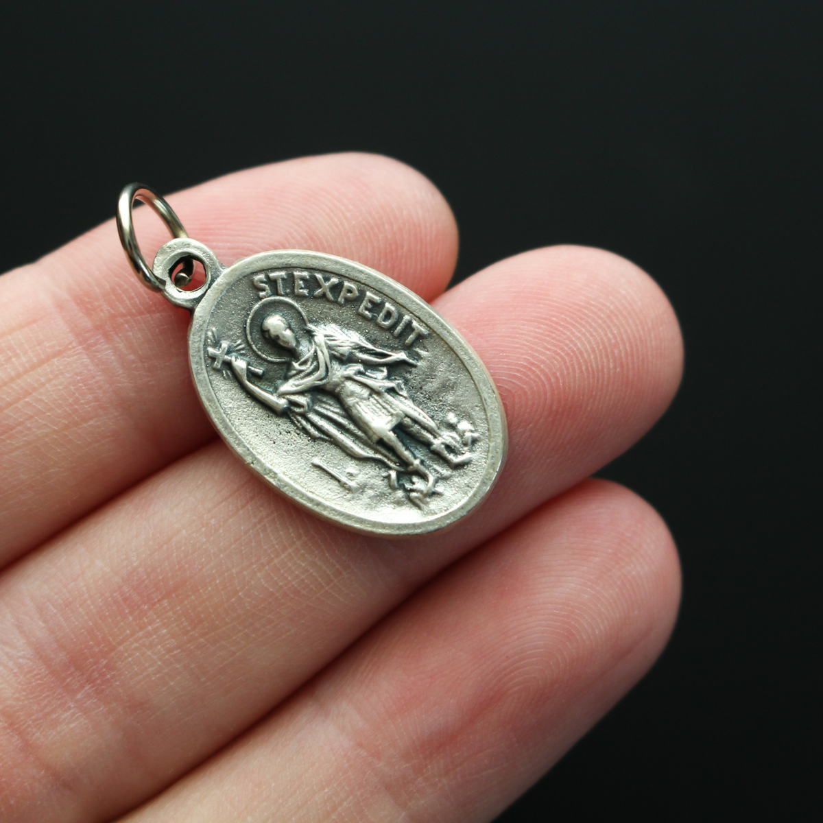Saint Expidito medal. The back is marked "Ruega Por Nosotros" Spanish for pray for us