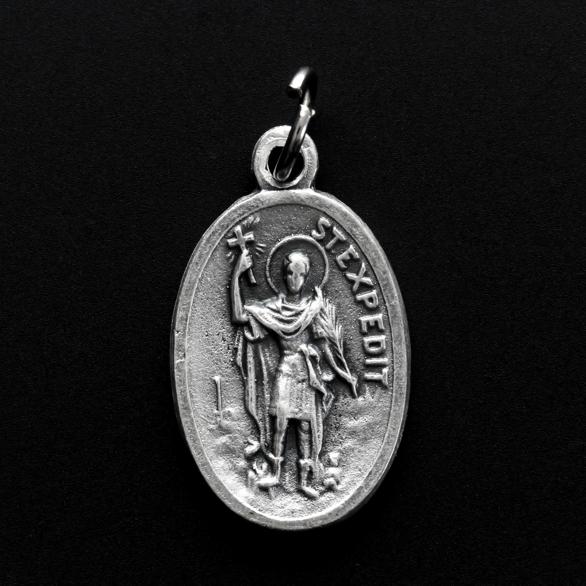 Saint Expidito medal. The back is marked "Ruega Por Nosotros" Spanish for pray for us