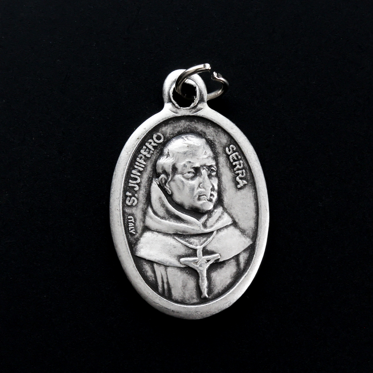 Saint Junípero Serra medal that depicts the saint on the front and "Pray For Us" on the back.