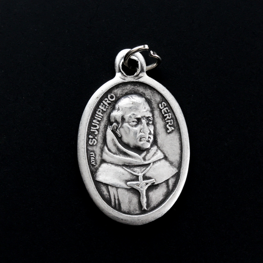 Saint Junípero Serra medal that depicts the saint on the front and "Pray For Us" on the back.