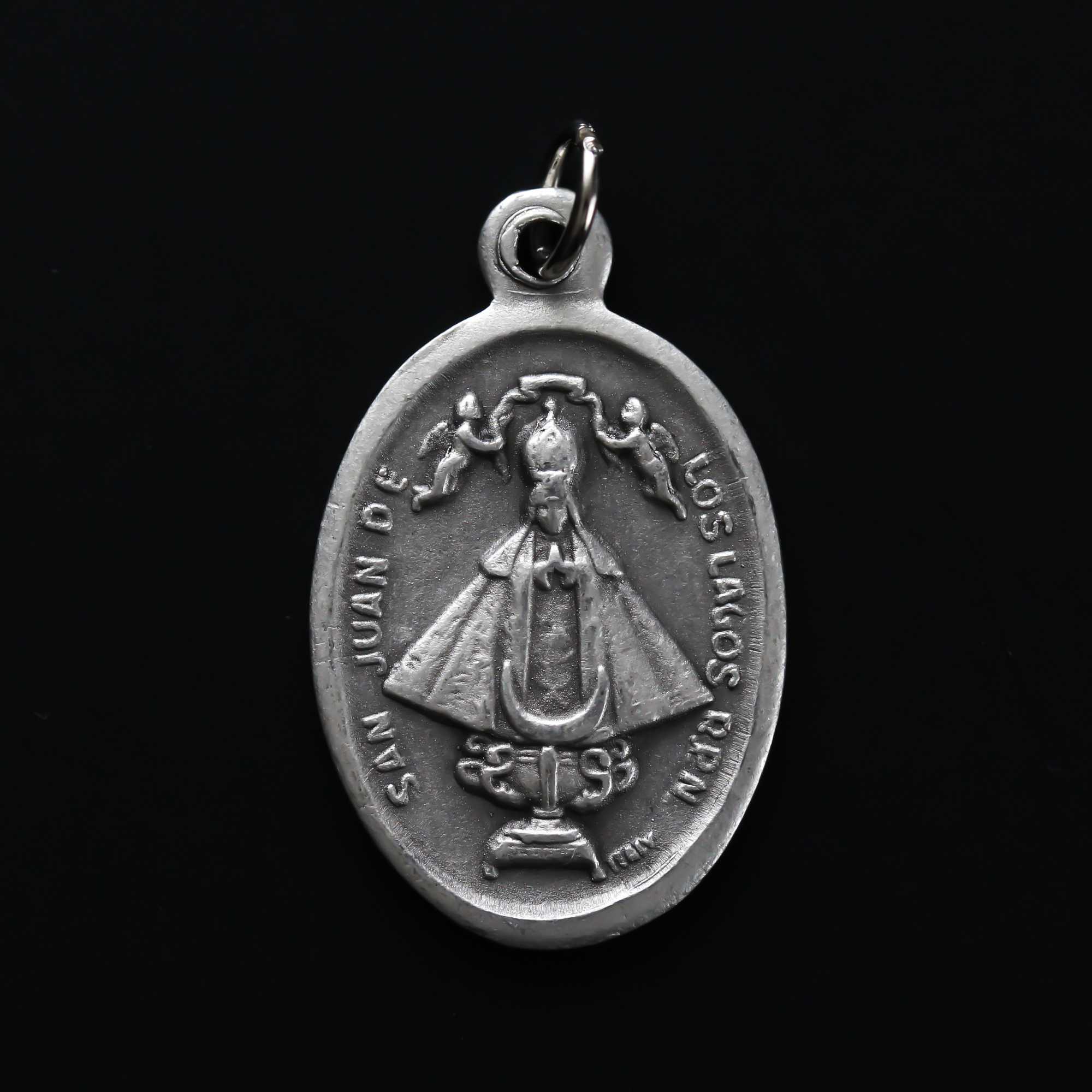 Our Lady of San Juan de Los Lagos medal that depicts the image of Our Lady on the front and the Sacred Heart of Jesus on the back