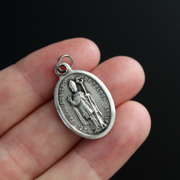 Saint Louis of Toulouse medal that depicts the saint on the front and the Mission San Luis Obispo de Tolosa on the back
