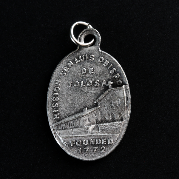 Saint Louis of Toulouse medal that depicts the saint on the front and the Mission San Luis Obispo de Tolosa on the back