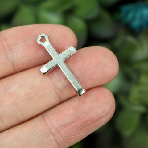 Simple silver tone cross charm with a classic design 24mm long