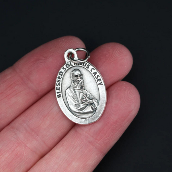 Blessed Solanus Casey medal that depicts the saint on the front and "Pray For Us" on the back