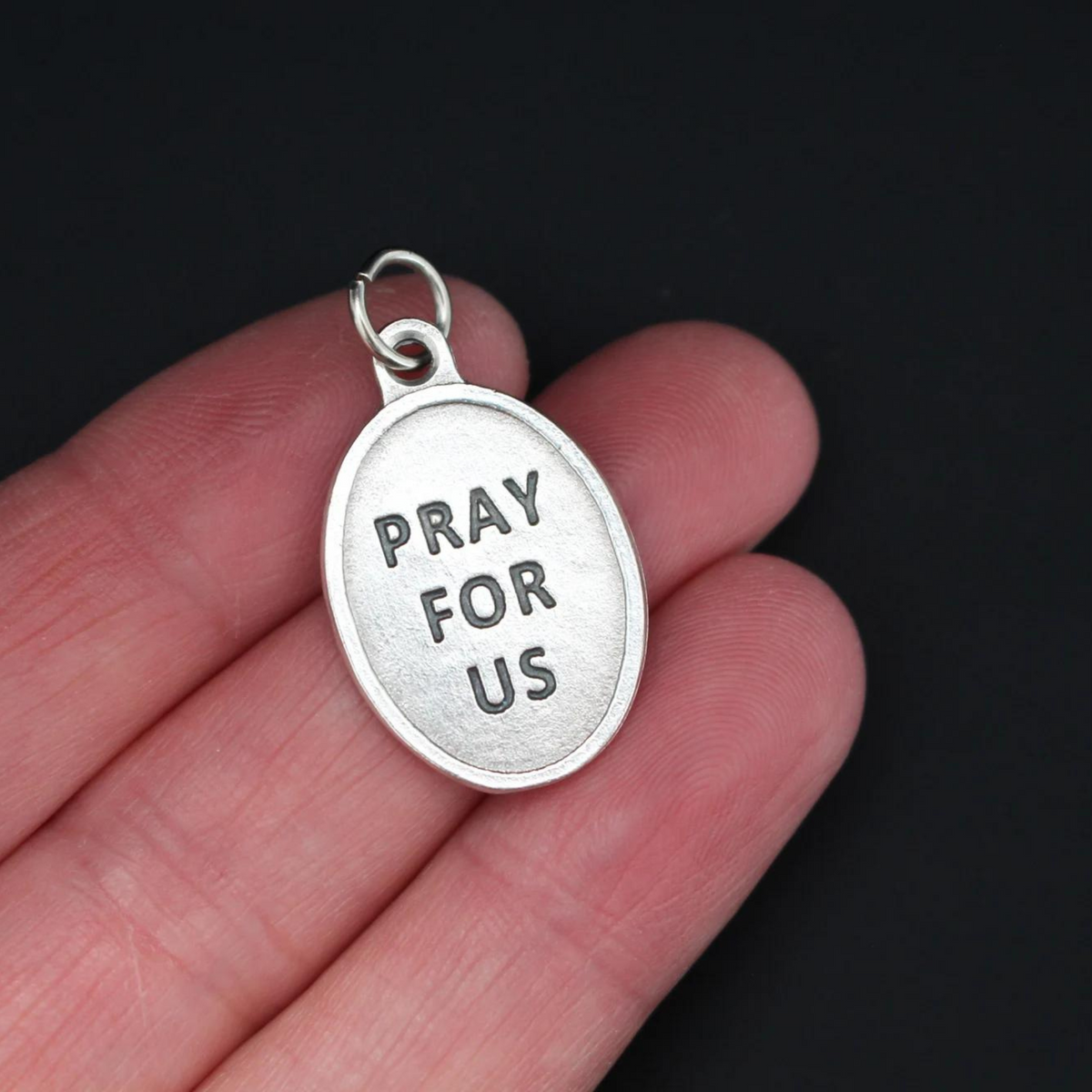 Blessed Solanus Casey medal that depicts the saint on the front and "Pray For Us" on the back