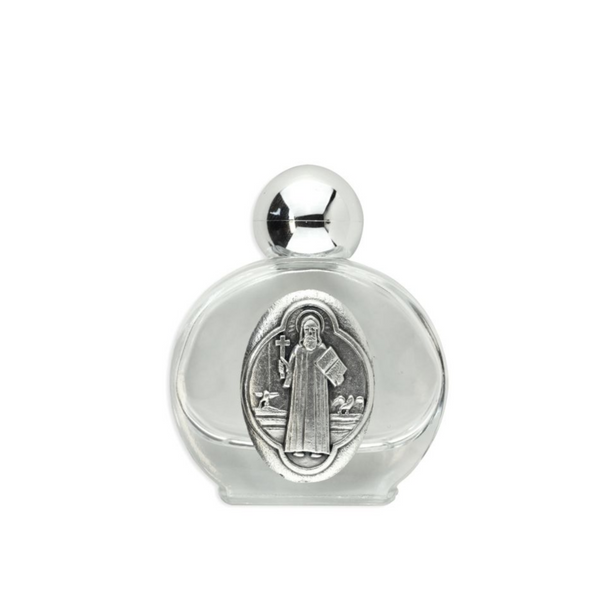 Glass holy water bottle with a metal embossed plaque of Saint Benedict on the front. Plastic screw on cap that is a shiny silver tone color.