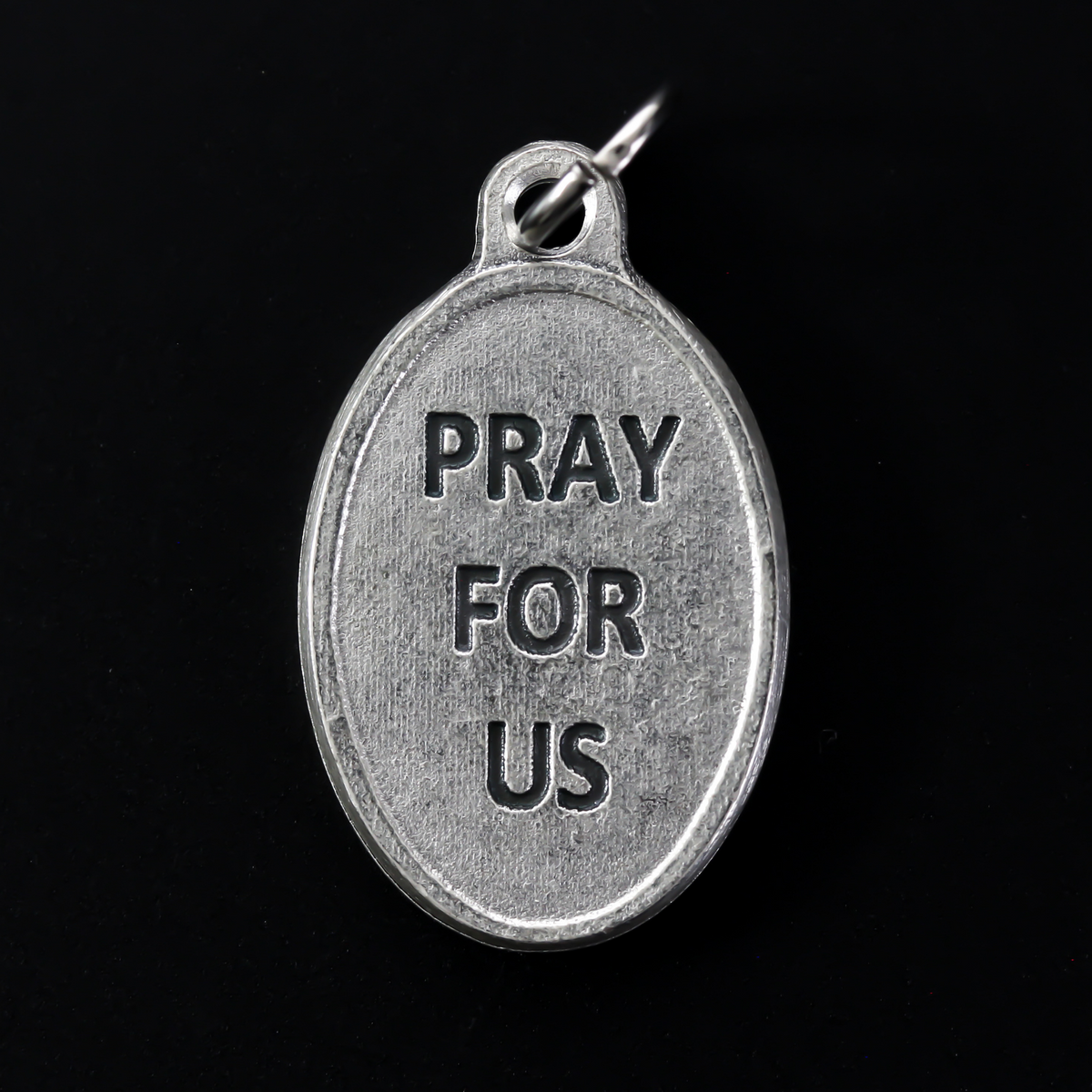 Saint Bernard of Clairvaux medal that depicts the saint on the front holding a church and crozier. Marked "Pray For Us" on the back