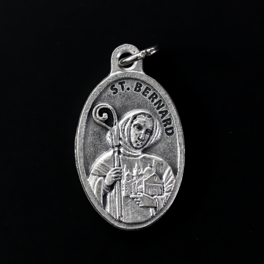 Saint Bernard of Clairvaux medal that depicts the saint on the front holding a church and crozier. Marked "Pray For Us" on the back