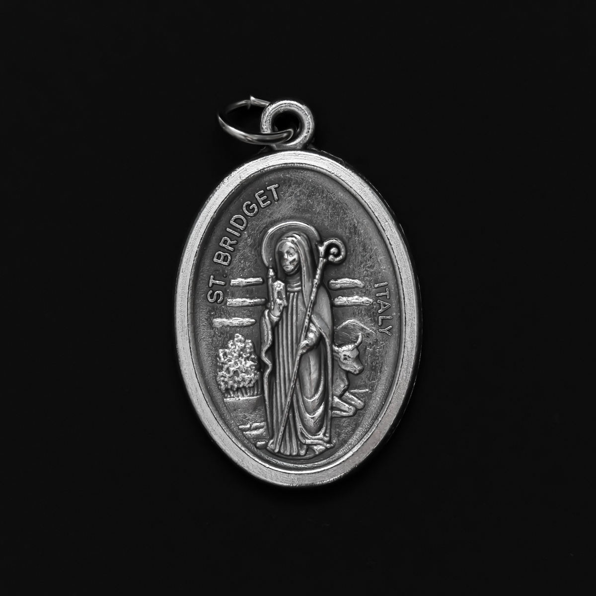 St. Bridget (Brigid) oval medal that depicts the saint on the front and "Pray For Us" on the back.