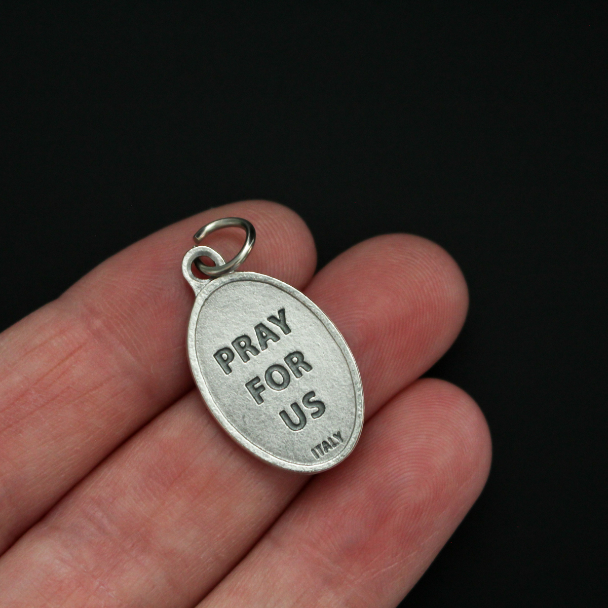 Saint Lorenzo Ruiz medal that depicts the saint on the front and is marked "Pray For Us" on the back