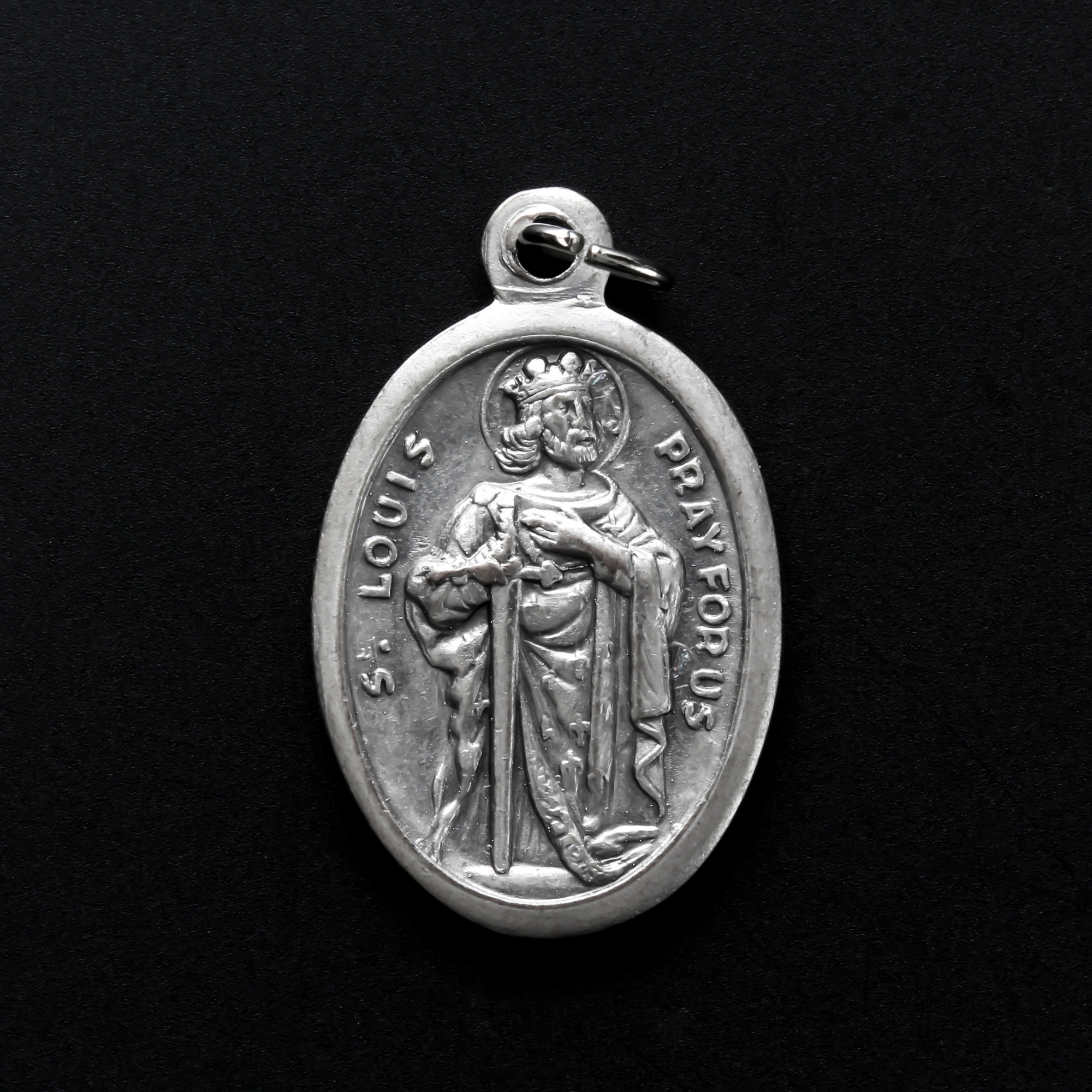 Saint Louis IX of France medal that depicts the saint on the front and is marked "Pray For Us" on the back.