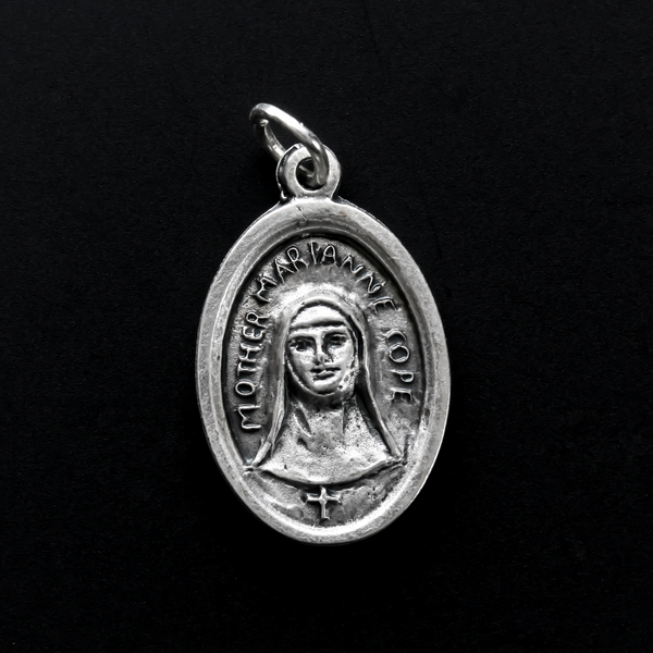 Saint Marianne Cope medal that depicts the saint on the front and is marked "Pray For Us" on the back.