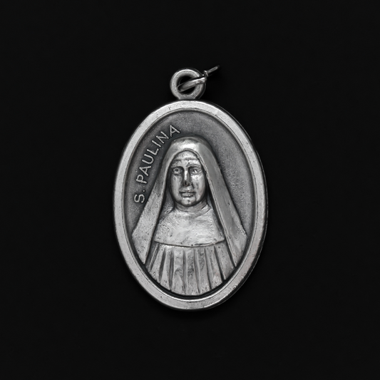 Saint Pauline medal that depicts the saint on the front and "Pray For Us" on the back