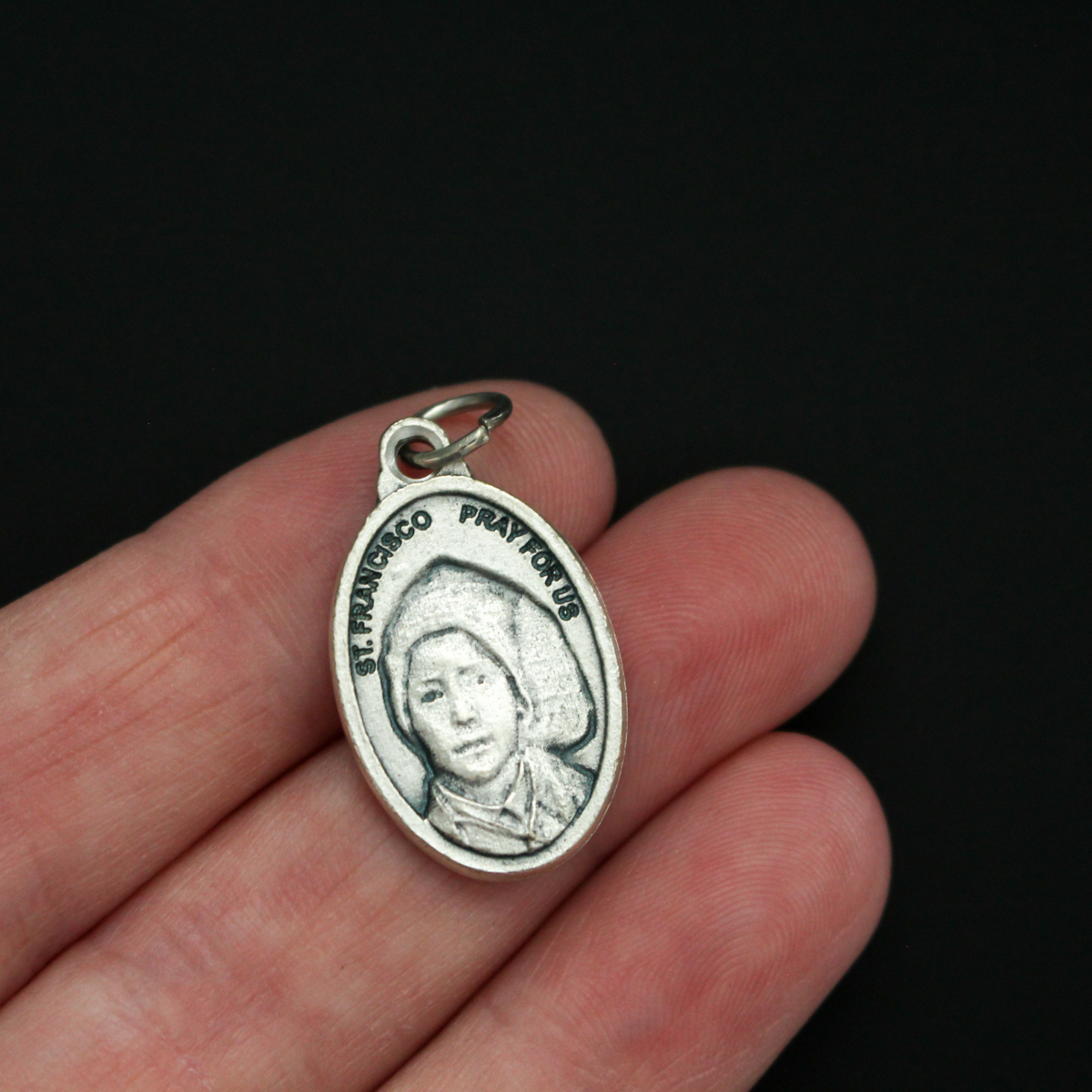 Saints Jacinta and Francisco Marto medal that depicts each saint on one side. Made in Italy.