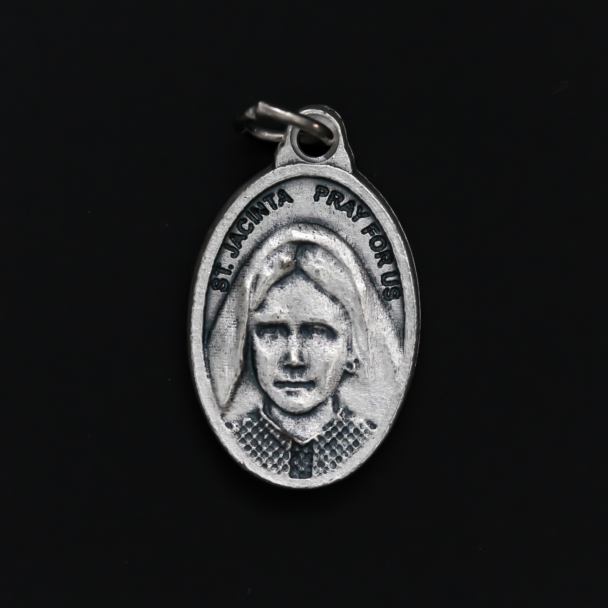 Saints Jacinta and Francisco Marto medal that depicts each saint on one side. Made in Italy.